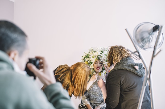 A team works on a flower fro and makeup for a photoshoot with Susan McLeary and and Amanda Dumouchelle Photography