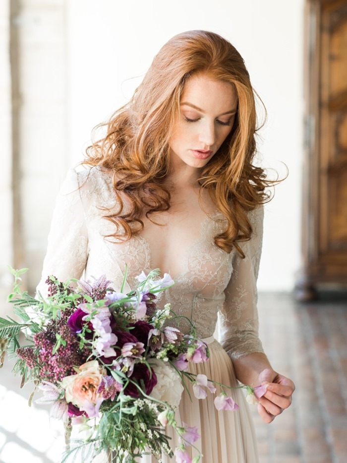 a bride with a purple bouquet by Laetitia Mayor 