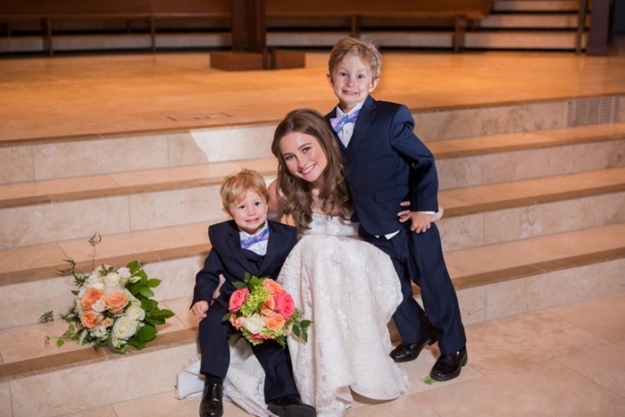 Bride and ringbearers sitting on altar steps bouquets by Fleur de Vie Houston photographed by MD Turner Photography