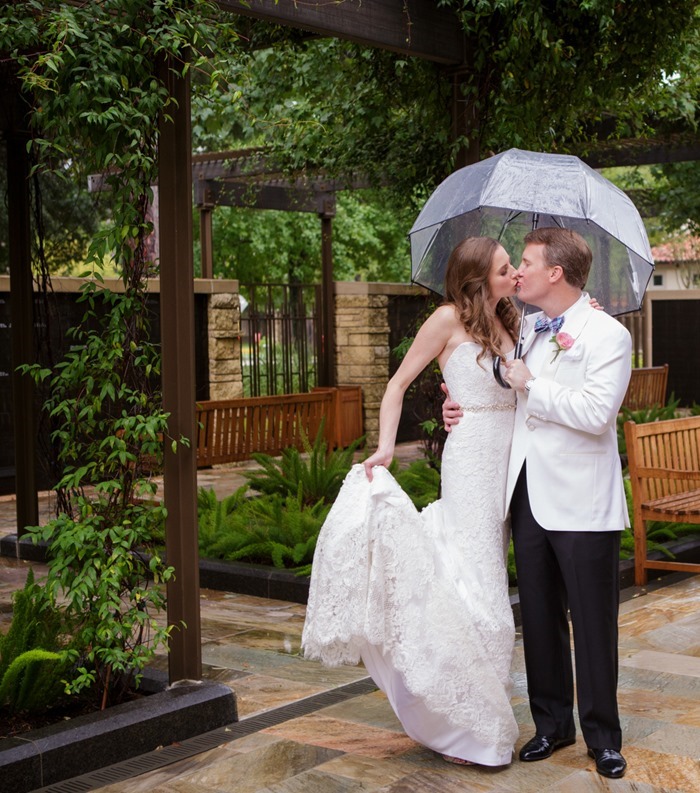 Bride and groom under umbrella photographed by MD Turner Photography