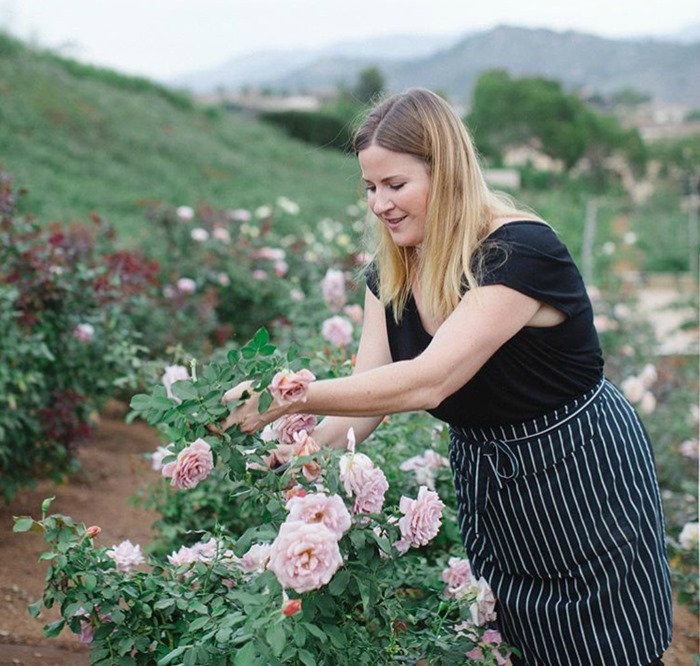 Nancy Teasley harvesting roses from Ella Rose Farm for designs at Oak and the Owl 