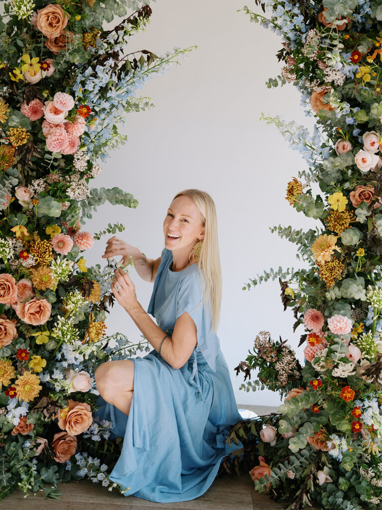 Floral creative entrepreneur Jen Lagedrost Cavender designing a floral arch